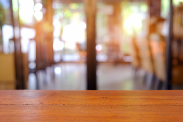 Wooden floor with blurred cafe background.