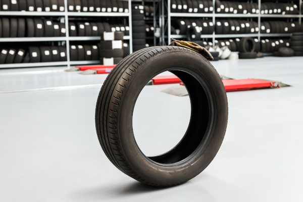 a tyre balancing on a mechanic's cleaned concrete flloor