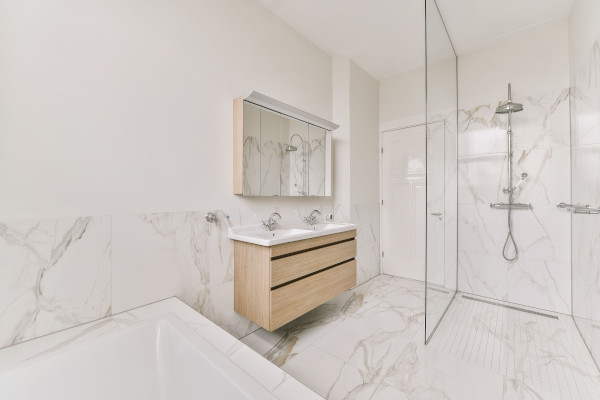 stylish shower and bathroom with beige marble floors