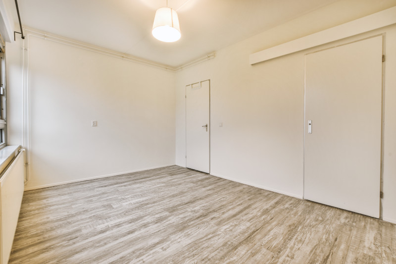 a clean wood effect laminate floor in an empty room