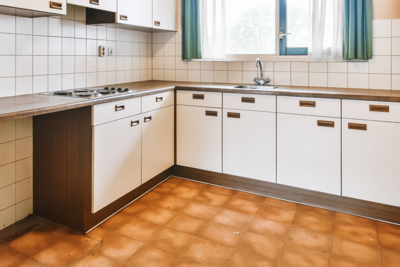 old kitchen with brown terracotta tiled floor