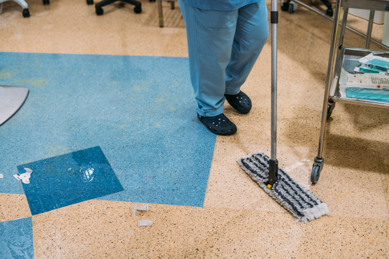 person cleaning an anti-slip safety floor in a hospital